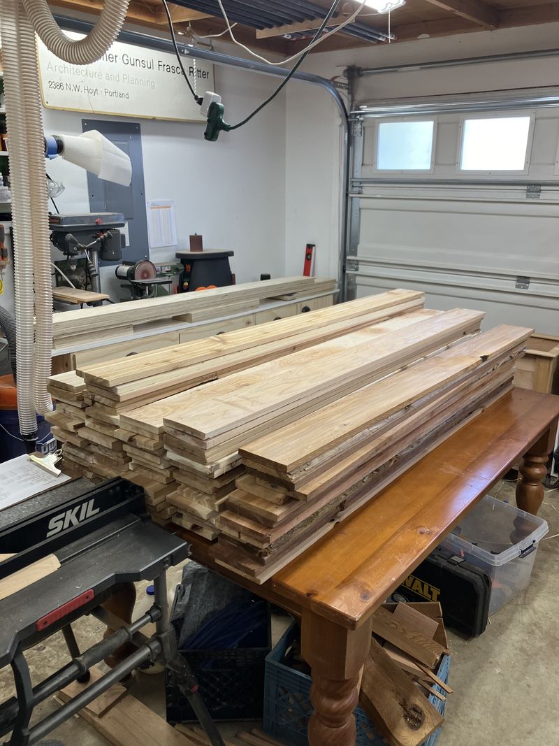 Stacks of cut cedar boards ready for assembly